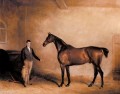 Mr C N Hoggs Claxton et un palefrenier dans un cheval stable John Ferneley Snr